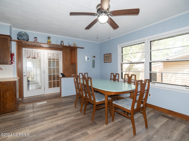 dining space featuring hardwood / wood-style flooring, ceiling fan, and crown molding