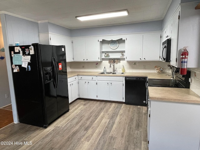 kitchen featuring white cabinets, sink, light hardwood / wood-style floors, and black appliances