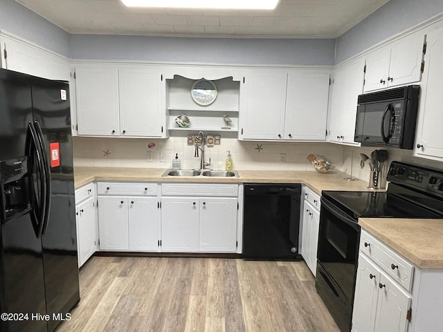 kitchen featuring white cabinets, sink, and black appliances