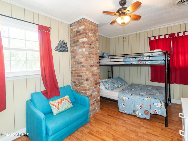 bedroom featuring wood-type flooring, ceiling fan, and crown molding