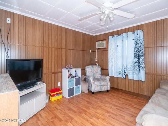 living room with light hardwood / wood-style floors and wooden walls