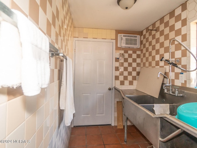 bathroom with tile patterned floors, a wall unit AC, and tile walls