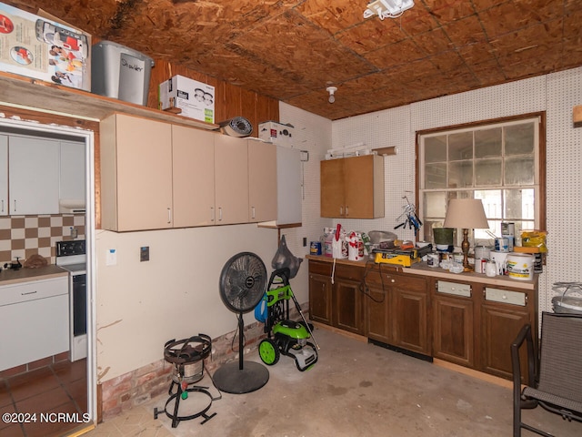 kitchen featuring white range and backsplash