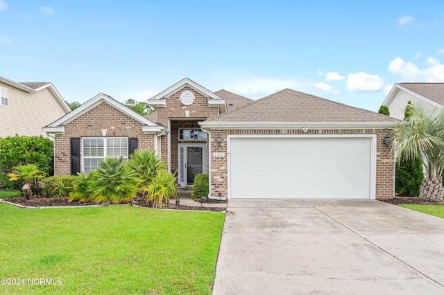 view of front of property featuring a front yard and a garage