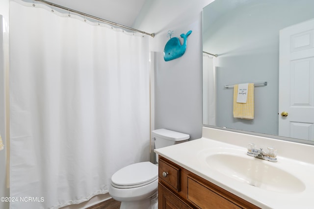 bathroom featuring curtained shower, hardwood / wood-style flooring, vanity, and toilet