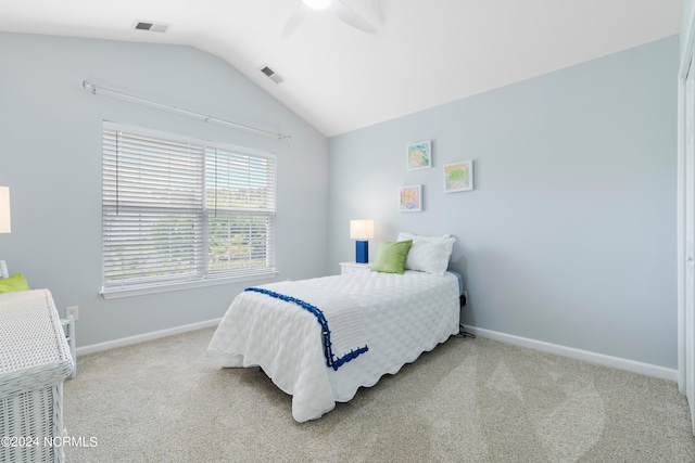 carpeted bedroom with ceiling fan and vaulted ceiling