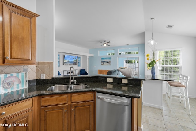 kitchen with ceiling fan, light tile patterned floors, sink, stainless steel dishwasher, and vaulted ceiling