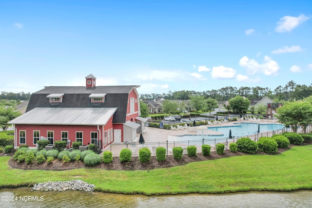 exterior space featuring a yard and a water view