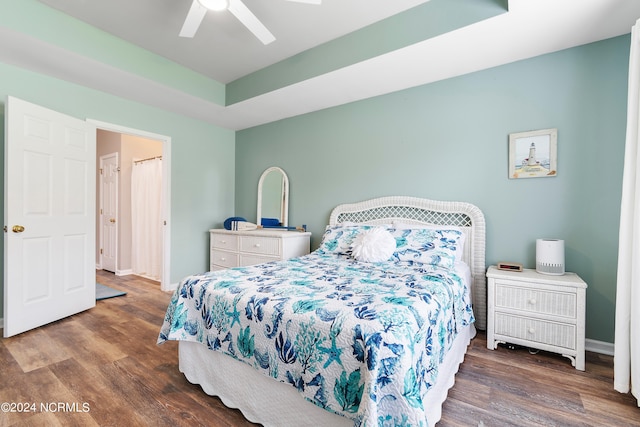 bedroom with ceiling fan and dark wood-type flooring