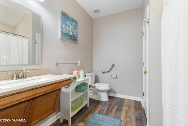 bathroom featuring hardwood / wood-style flooring, vanity, and toilet