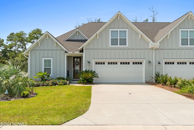 view of front of home with a front yard and a garage