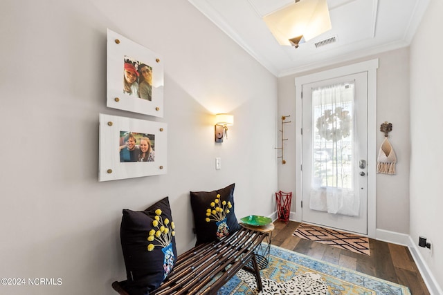 foyer entrance featuring crown molding, dark wood-type flooring, and plenty of natural light