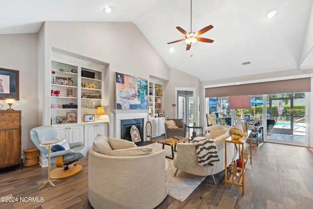 living room featuring dark hardwood / wood-style flooring, high vaulted ceiling, and ceiling fan