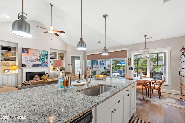 kitchen featuring dark hardwood / wood-style flooring, sink, white cabinetry, ceiling fan, and light stone counters