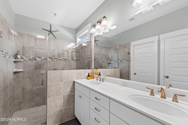 bathroom featuring vanity, tile walls, and walk in shower