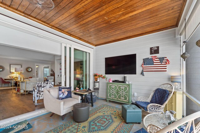 interior space featuring wooden ceiling, crown molding, hardwood / wood-style floors, and wooden walls