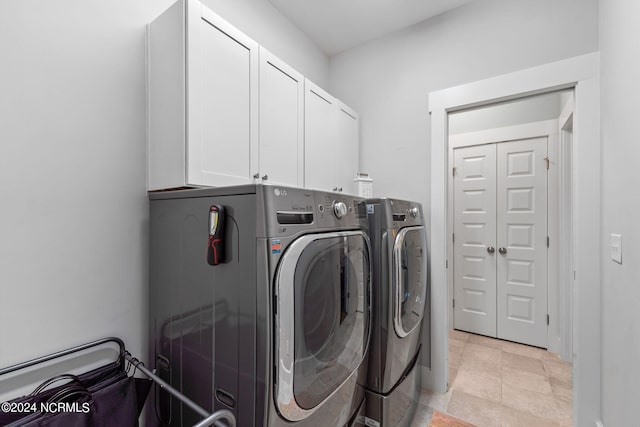 laundry room with cabinets and washing machine and clothes dryer