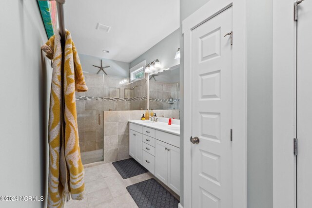 bathroom featuring tile walls, tile patterned flooring, an enclosed shower, and vanity