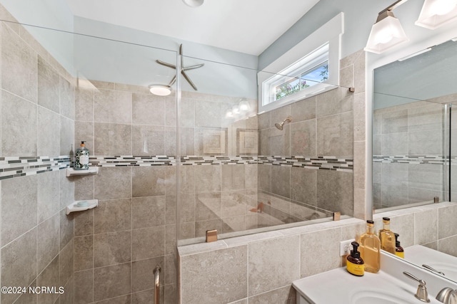 bathroom featuring vanity and tiled shower