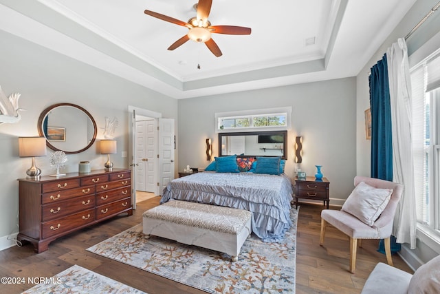 bedroom featuring ornamental molding, a raised ceiling, ceiling fan, and dark hardwood / wood-style floors