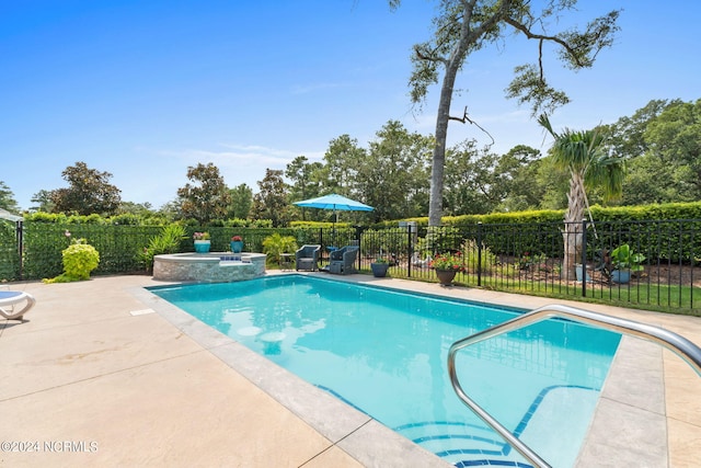 view of pool with a patio and an in ground hot tub