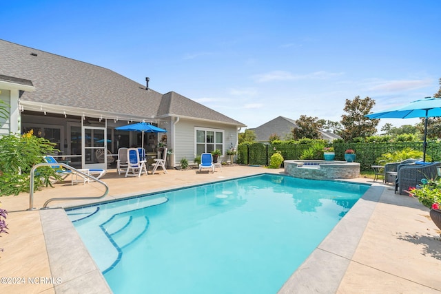 view of pool with a patio area and an in ground hot tub