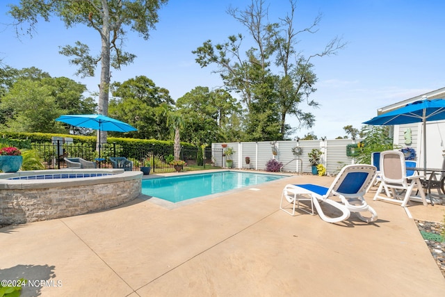 view of swimming pool with an outdoor fire pit and a patio area