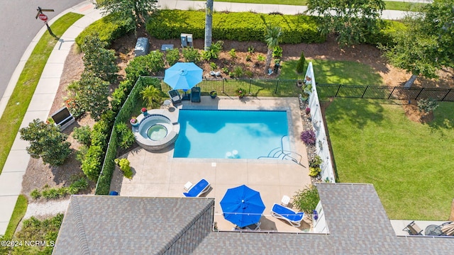 view of pool featuring a lawn and a patio