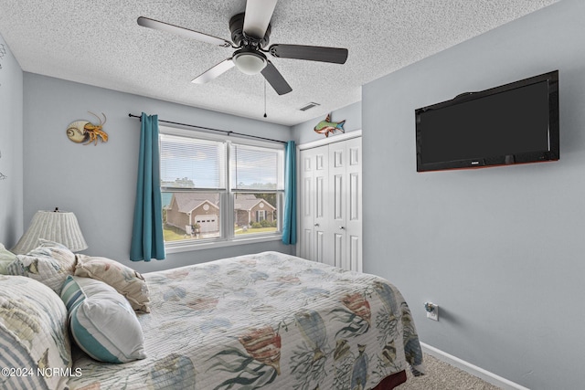 carpeted bedroom featuring a textured ceiling, a closet, and ceiling fan