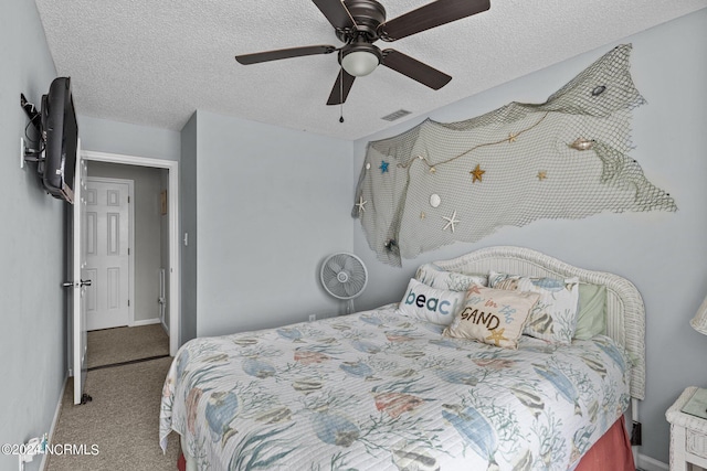 bedroom featuring a textured ceiling, carpet floors, and ceiling fan