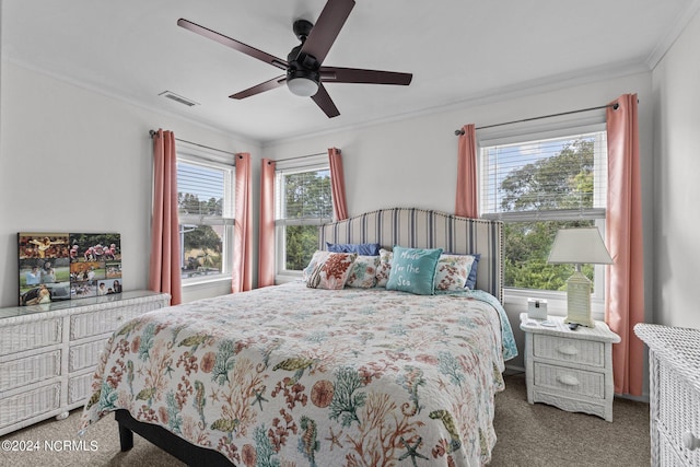 carpeted bedroom with ceiling fan and ornamental molding