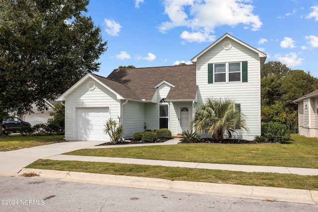 view of front of home with a garage and a front yard