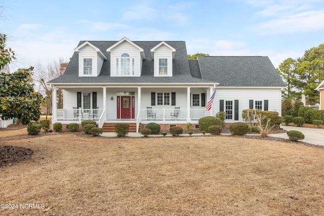 new england style home featuring covered porch