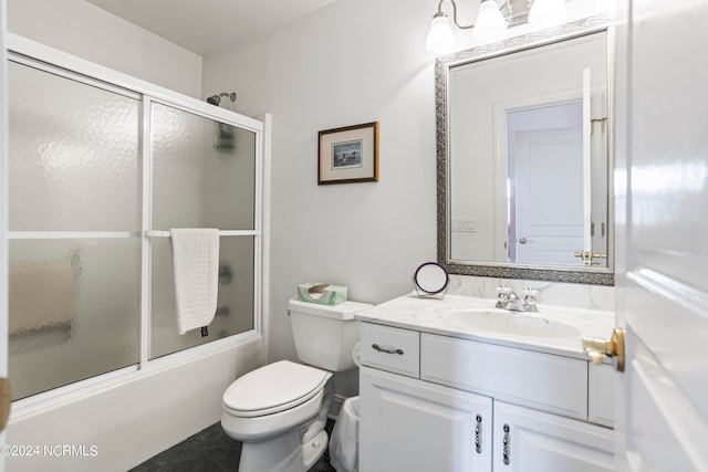 full bathroom featuring vanity, toilet, and bath / shower combo with glass door