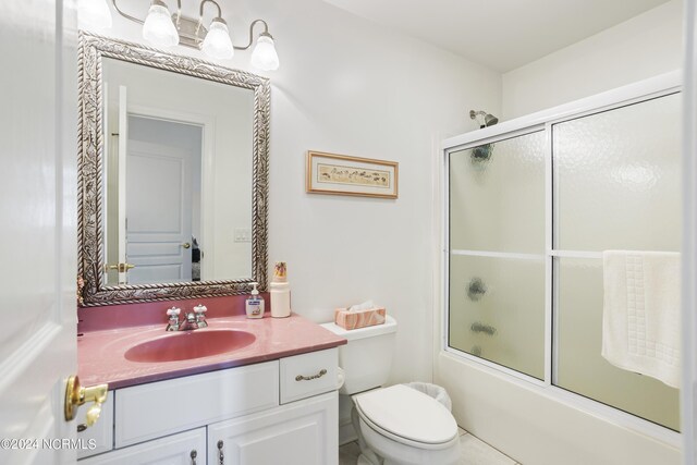 full bathroom featuring vanity, toilet, tile patterned flooring, and enclosed tub / shower combo