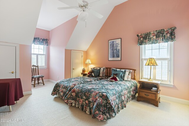 carpeted bedroom featuring ceiling fan and vaulted ceiling