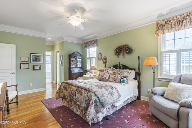 bedroom featuring ceiling fan, ornamental molding, and light hardwood / wood-style flooring