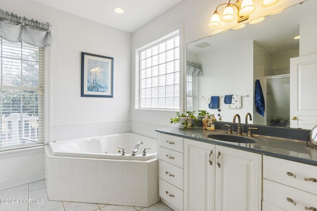 bathroom with vanity, shower with separate bathtub, and tile patterned flooring