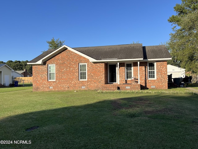 ranch-style home featuring a front yard