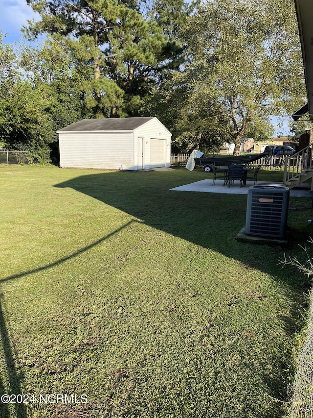 view of yard featuring a patio, a storage unit, and central air condition unit