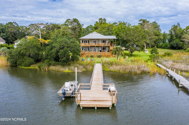 view of dock featuring a balcony and a water view