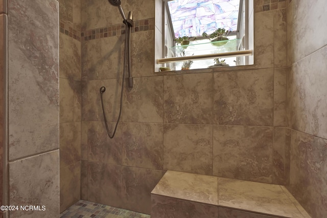 full bath featuring tiled shower