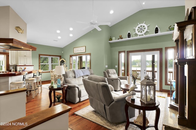 living room featuring ceiling fan, light wood-type flooring, recessed lighting, french doors, and high vaulted ceiling