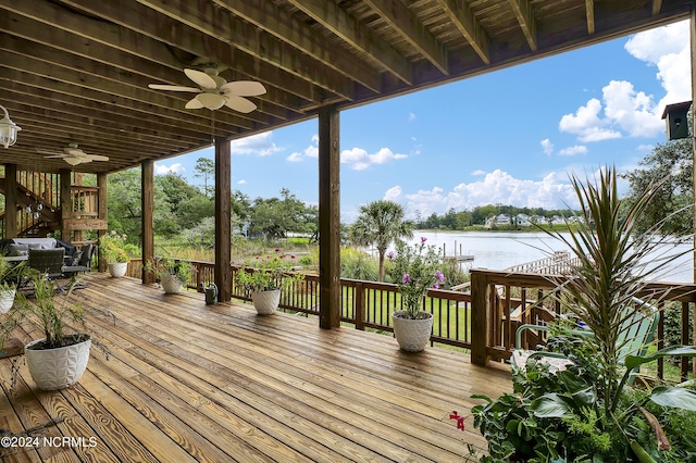 wooden deck featuring a water view and ceiling fan