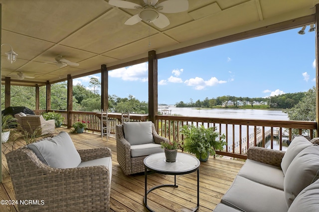 wooden deck featuring a ceiling fan, a water view, and an outdoor hangout area