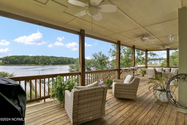 wooden deck featuring outdoor lounge area, a grill, a water view, and ceiling fan