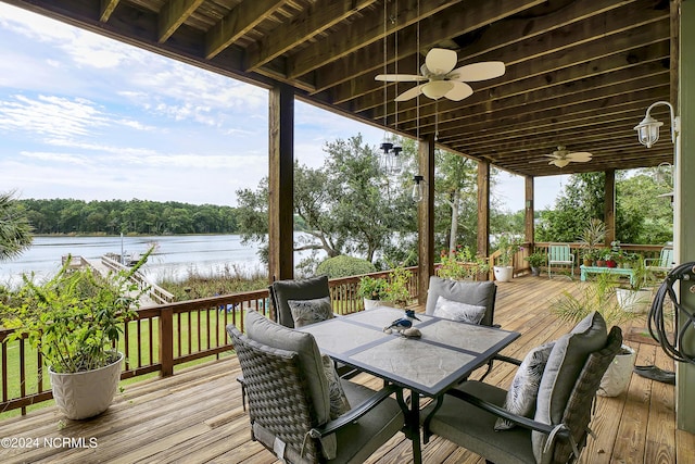 deck featuring a water view, ceiling fan, and outdoor dining space