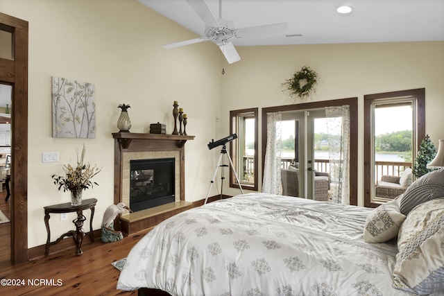 bedroom with wood finished floors, baseboards, a fireplace, french doors, and access to outside