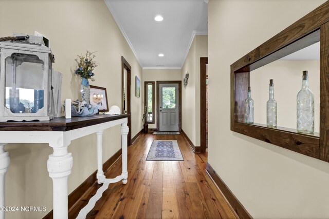 interior space featuring recessed lighting, baseboards, ornamental molding, and hardwood / wood-style flooring