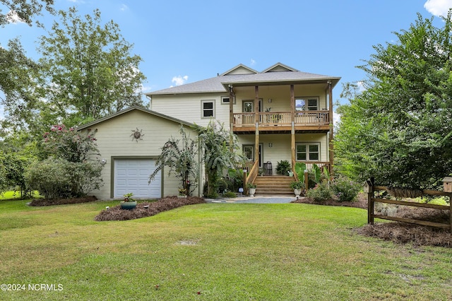 exterior space with a yard, a balcony, an attached garage, and fence